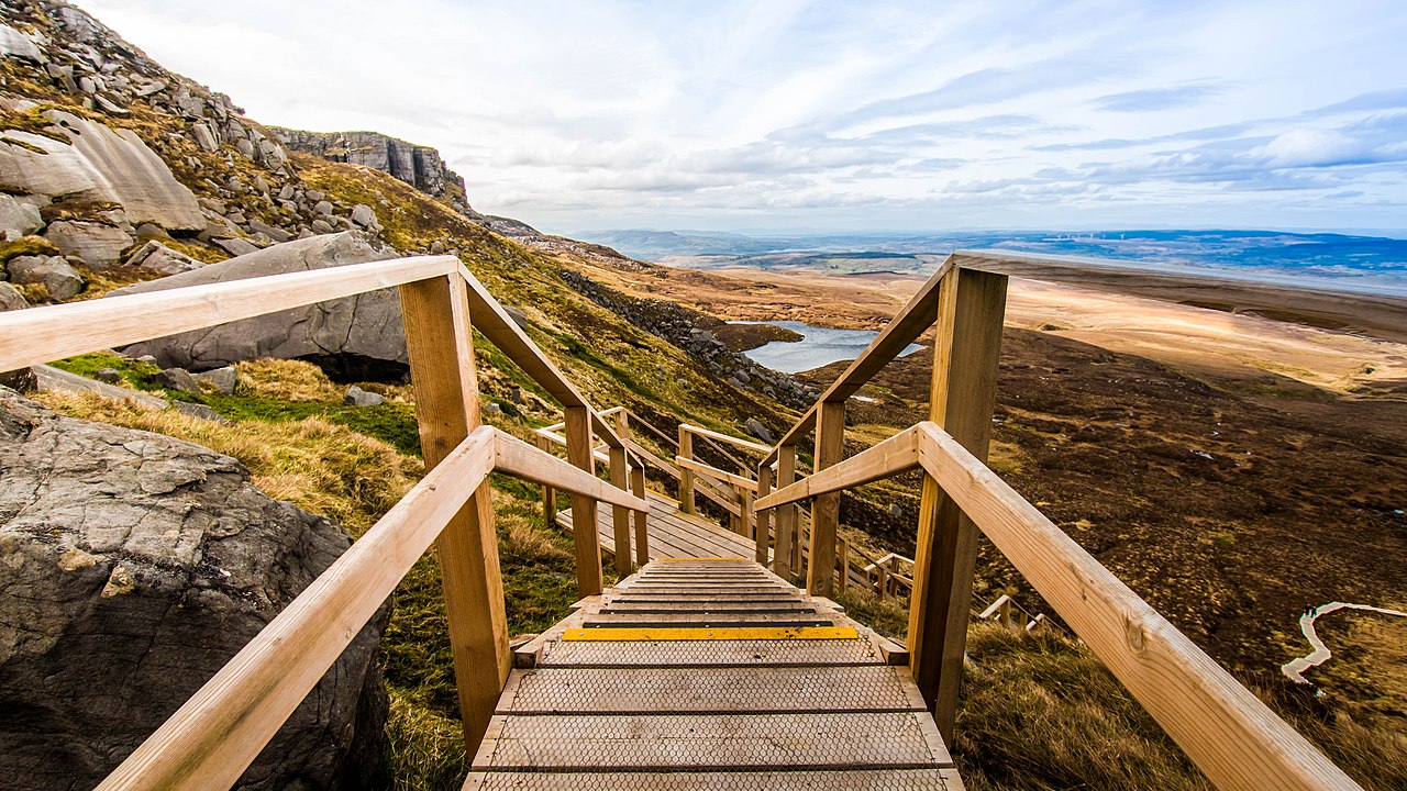 A first person view looking down the 'Stairway to Heaven' Boardwalk in Cuilcagh Mountain, Ireland. Cuilcagh is a mountain on the border between County Fermanagh and County Cavan. The boardwalk is a wooden pathway constructed through the rocky mountainous area.