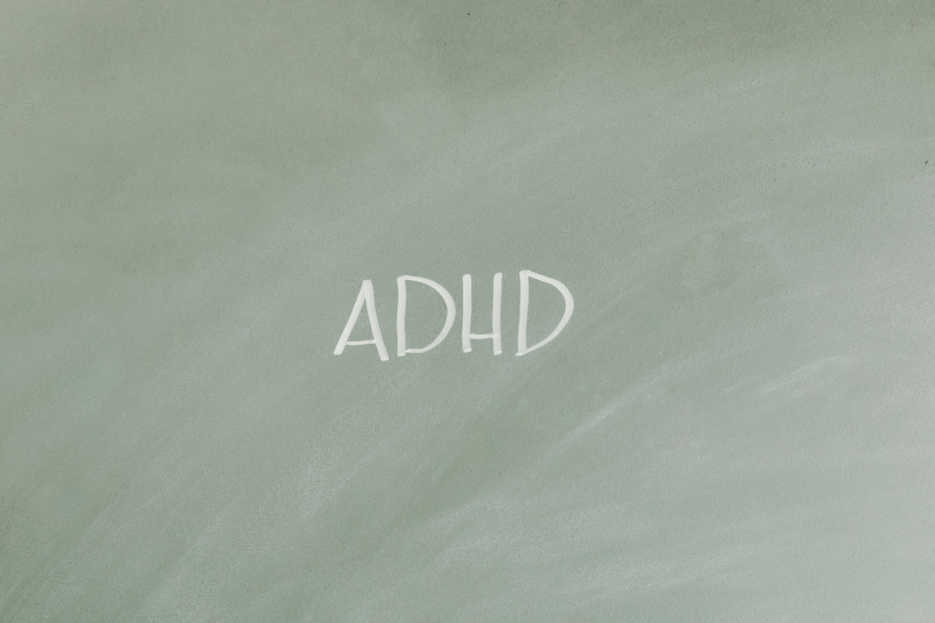 An image showing some chalk writing of the term 'ADHD'