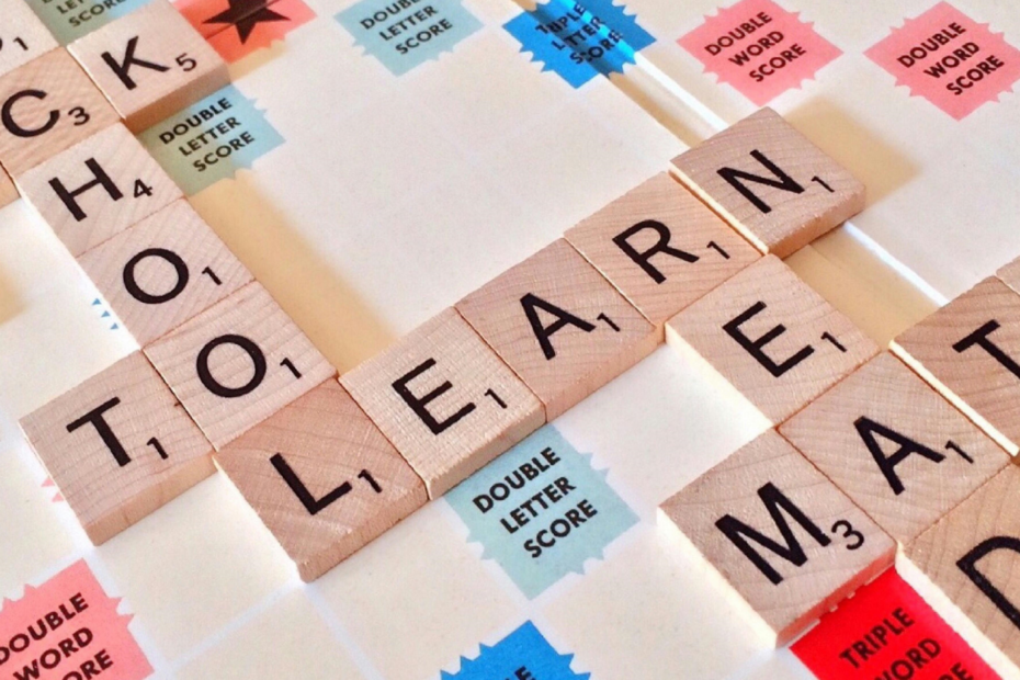 A picture of a Scrabble board showing words such as 'school', 'learn' and 'read'.