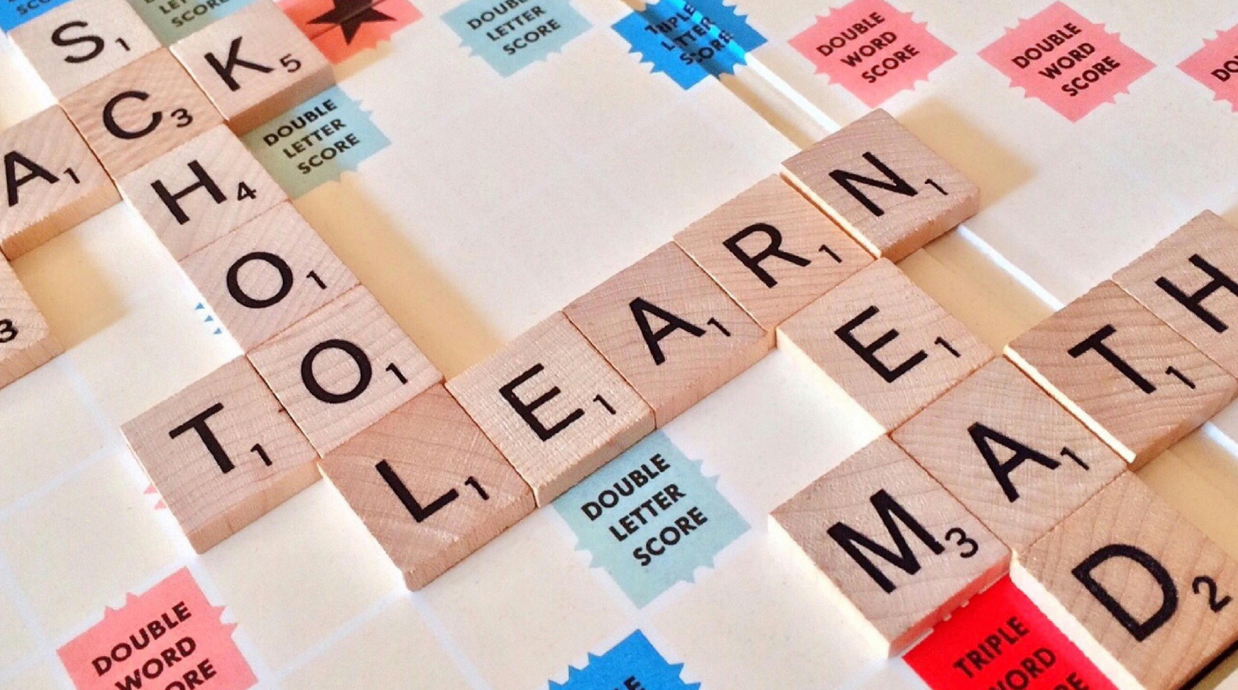 A picture of a Scrabble board showing words such as 'school', 'learn' and 'read'.